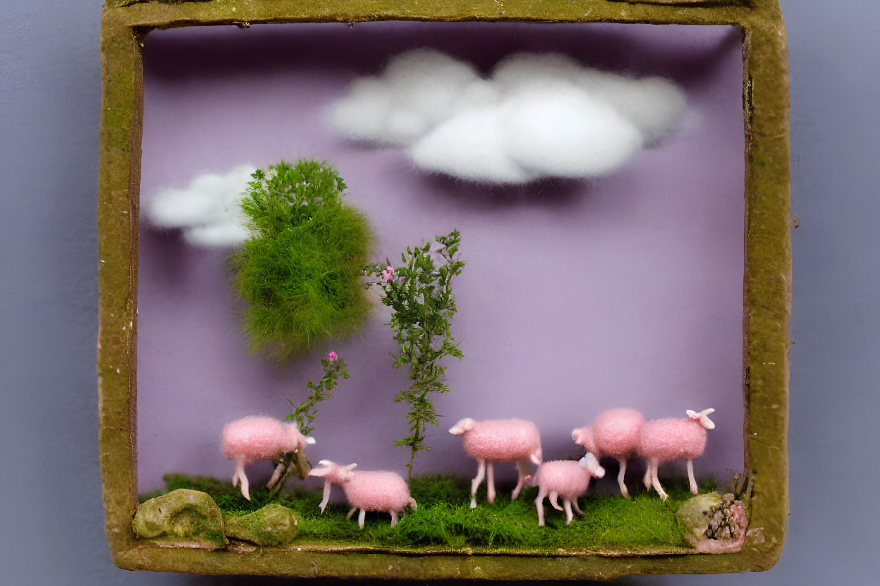 Pink sheep, greenery, clouds on purple backdrop in rustic frame