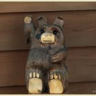 Illustrated bear playing with soap bubbles on wooden background