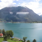 Tranquil lake with islands, greenery, and striped mountains