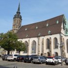 European square with fountain and gothic cathedral on sunny day