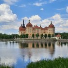 Grand multi-spired building reflected in tranquil lake with lush greenery - watercolor painting