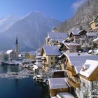 Snowy Winter Landscape with Houses, Trees, River, and Twilight Sky