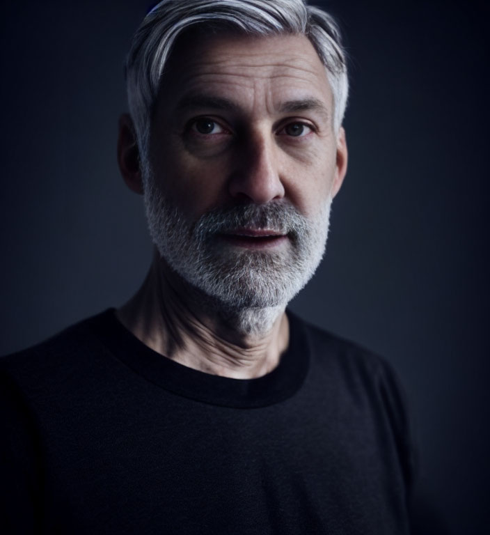 Mature Man with Grey Hair and Beard in Black Shirt Portrait