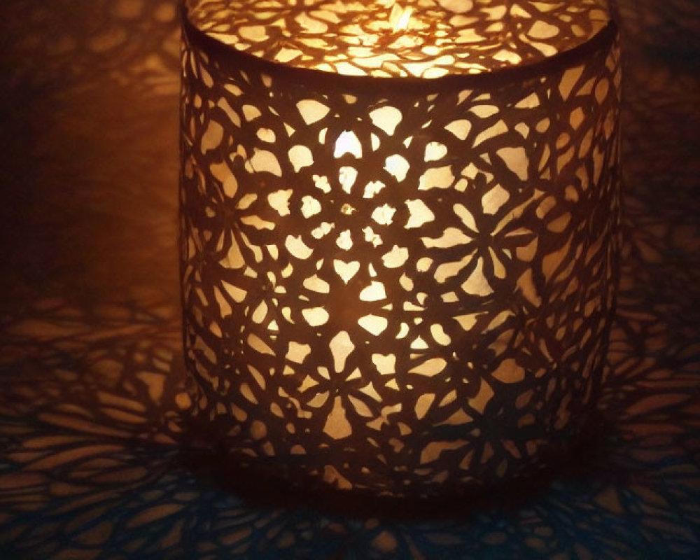 Intricate Cut-Out Pattern Candle Holder Casting Warm Glow