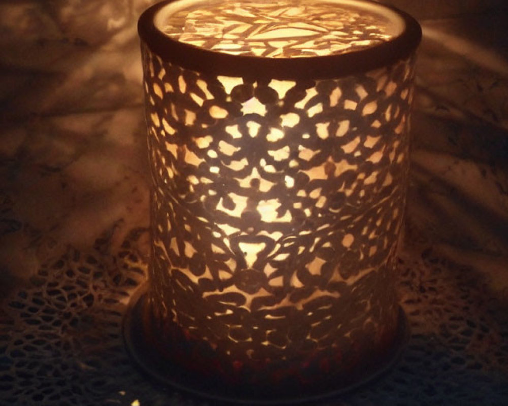 Warm Glow and Shadow Patterns Cast by Lit Candle in Pierced Metal Lantern