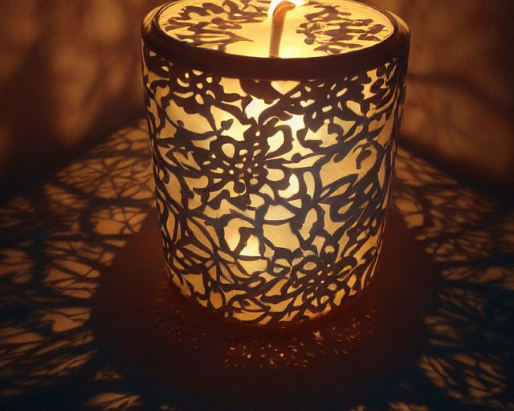 Decorative candle holder casting intricate shadows with warm glow