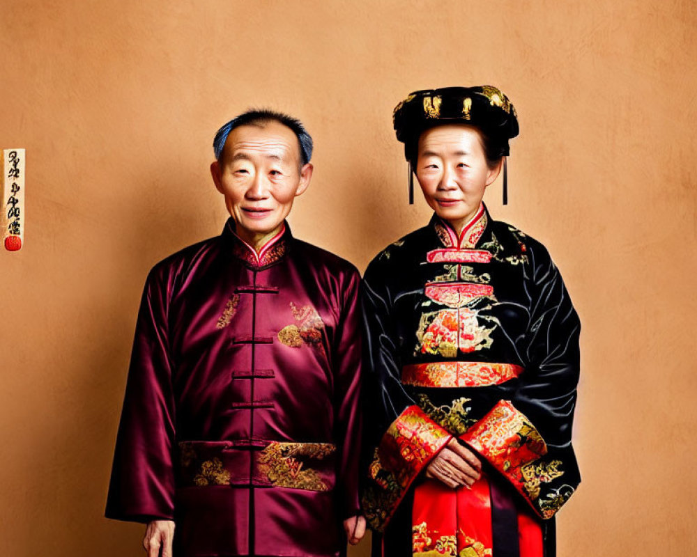 Elderly Couple in Traditional Chinese Attire Against Warm Orange Background