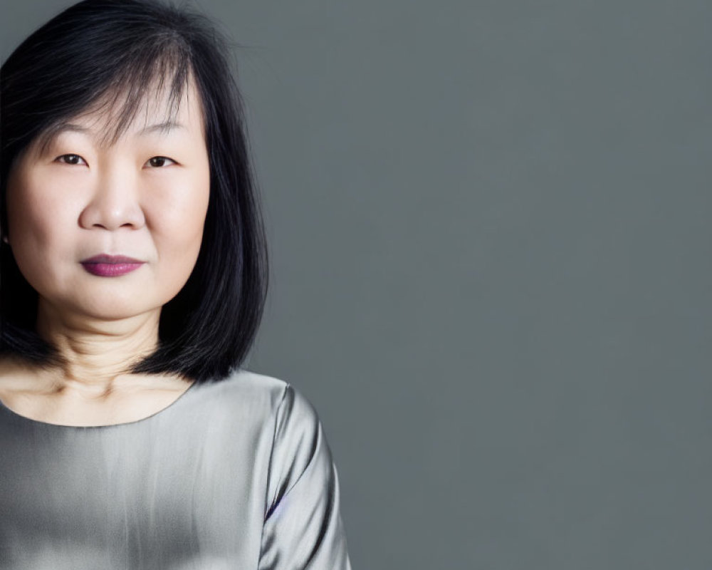 Smiling East Asian Woman Portrait in Silver Blouse