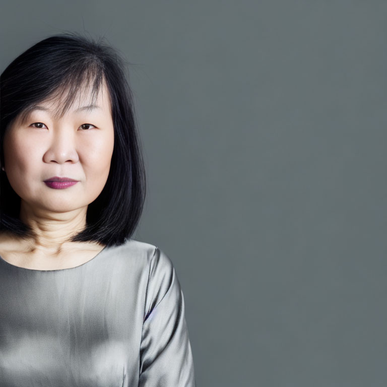 Smiling East Asian Woman Portrait in Silver Blouse