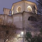 Nocturnal Illustration: Old Building with Arched Windows, Tower, Trees, and Fence in