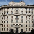 Historical building with ornate beige facades and rooftop garden