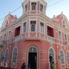 Pink Baroque-style Building with Elaborate Decorations and People Entering