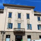 Beige Building with Moldings, Shutters, and Balcony under Blue Sky