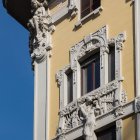 Ornate Building Facade with Decorative Moldings and Wood-Framed Window