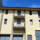 Vintage building with balconies in watercolor effect under blue sky