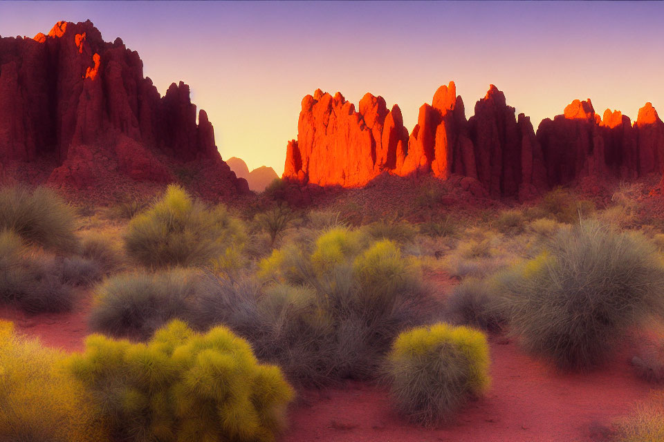 Scenic sunset illuminating rocky desert landscape with green shrubs.