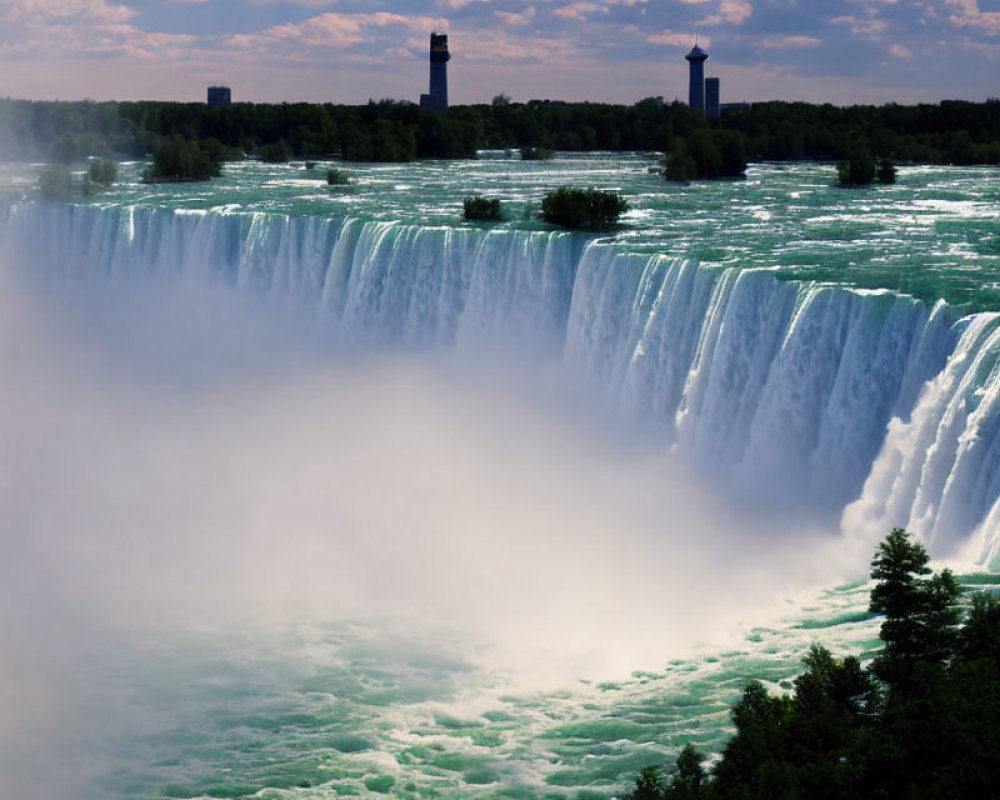 Panoramic view of misty Niagara Falls under clear skies