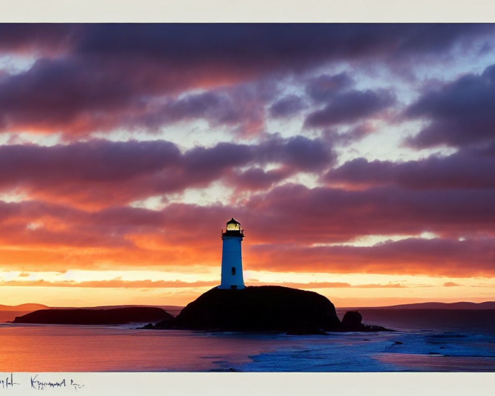 Vibrant orange and red sunset behind a solitary coastal lighthouse