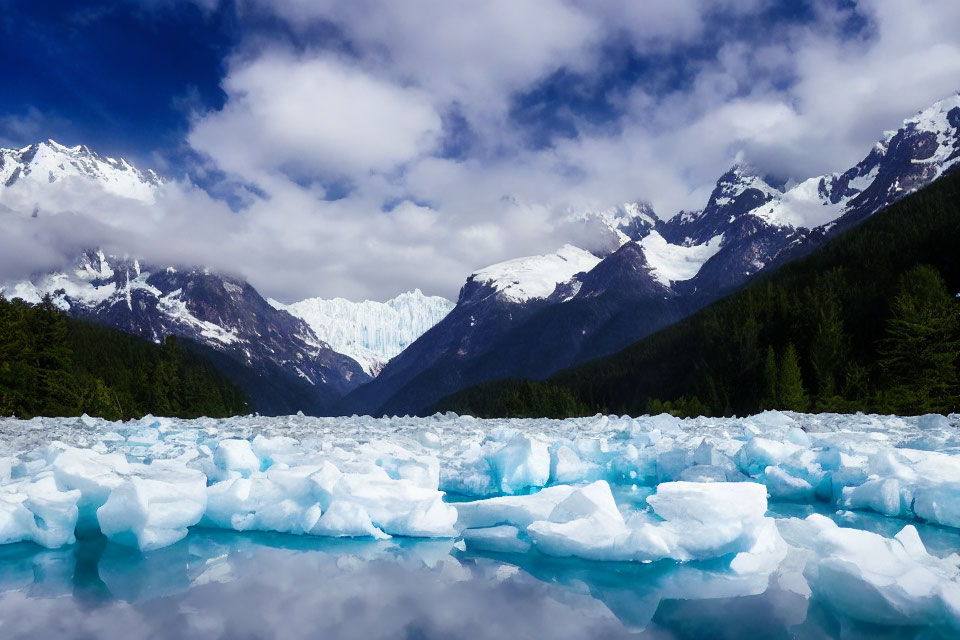 Scenic landscape with icy lake, snowy mountains, and glacier under blue sky