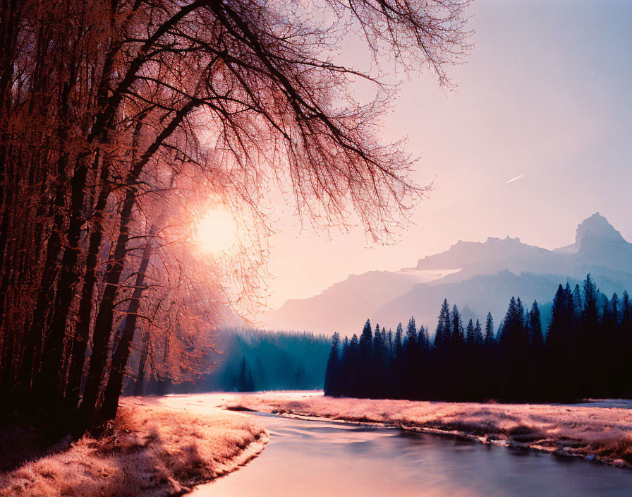 Tranquil river sunset with reflective water and mountain backdrop