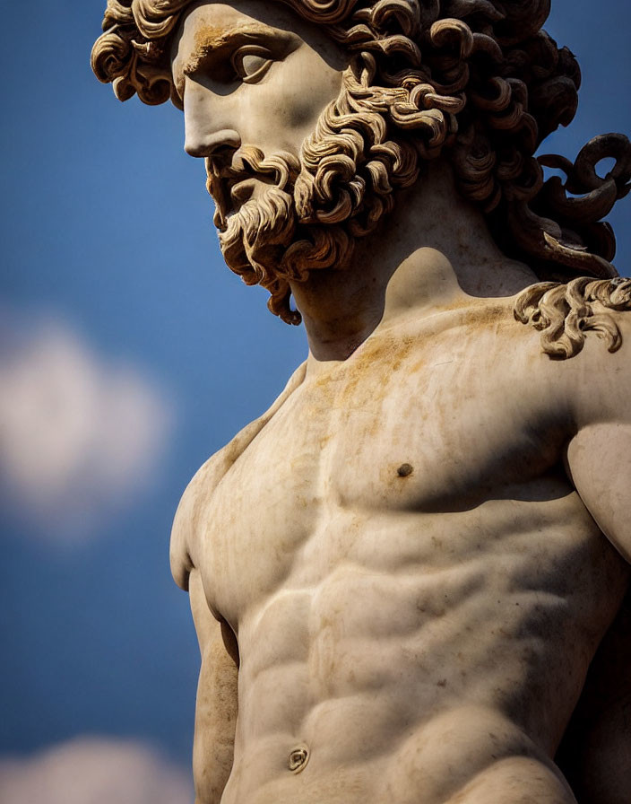 Classic Marble Statue: Muscular Male Figure with Curly Hair and Beard against Blue Sky