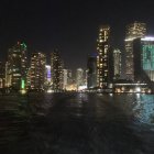 Nighttime Cityscape with Illuminated Skyscrapers and Starry Sky