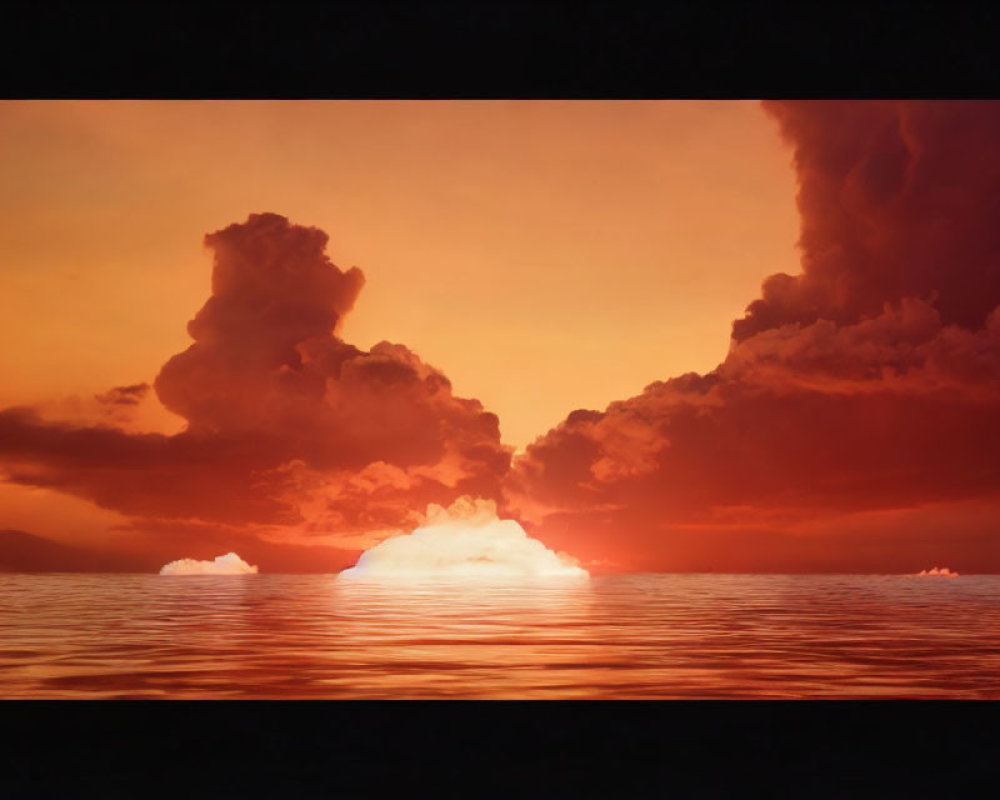 Vibrant orange sunset over ocean with fiery sky and cloud silhouettes