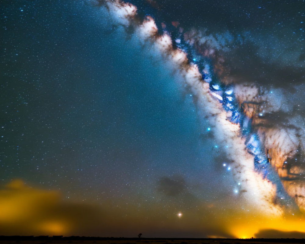 Vibrant Milky Way over grassy field under starry night sky