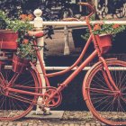 Colorful Pink Bicycle with Flower Baskets in Twilight Floral Setting