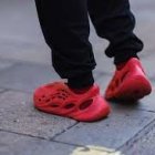 Vibrant Red and Orange Sneakers on Ice with Sparkling Background