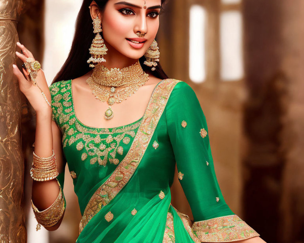 Traditional Indian woman in green saree with gold embroidery and ornate jewelry posing gracefully.