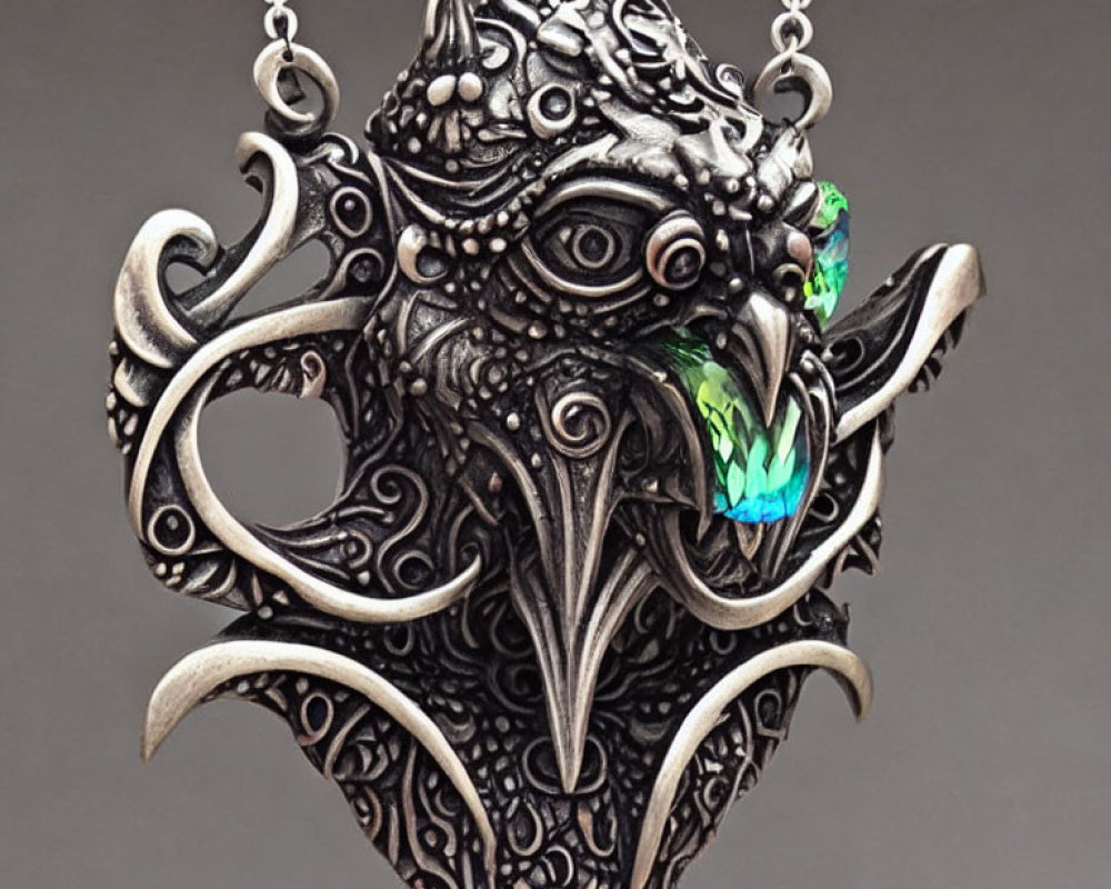 Silver Dragon Pendant with Green Gemstone on Gray Background