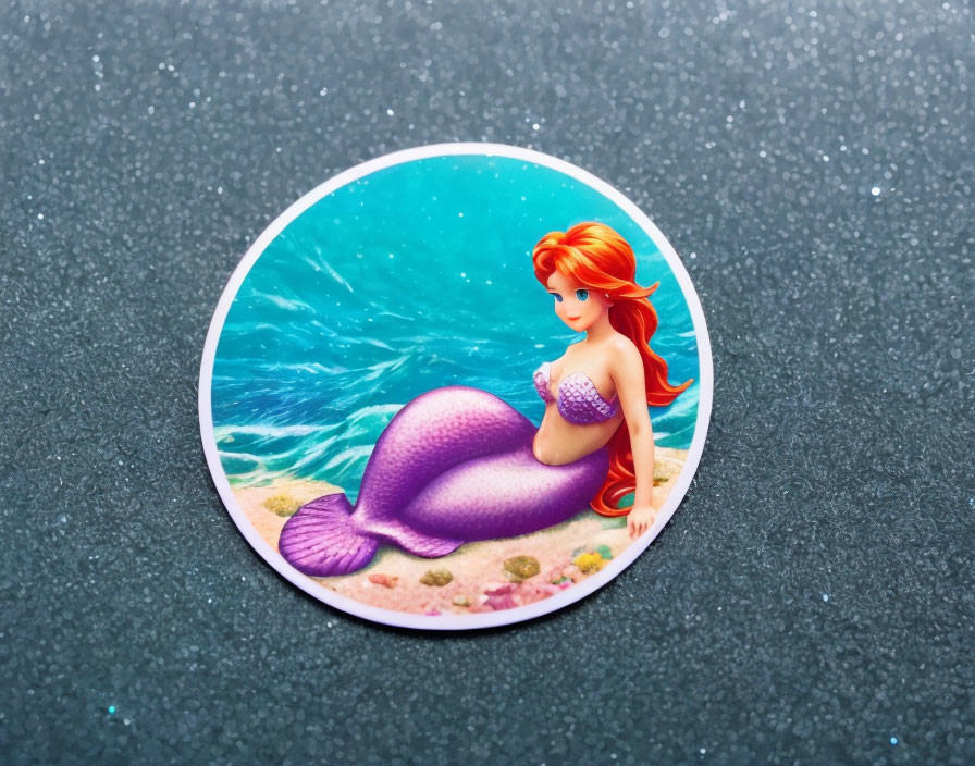 Circular Mermaid Sticker with Red Hair and Purple Tail on Underwater Rock