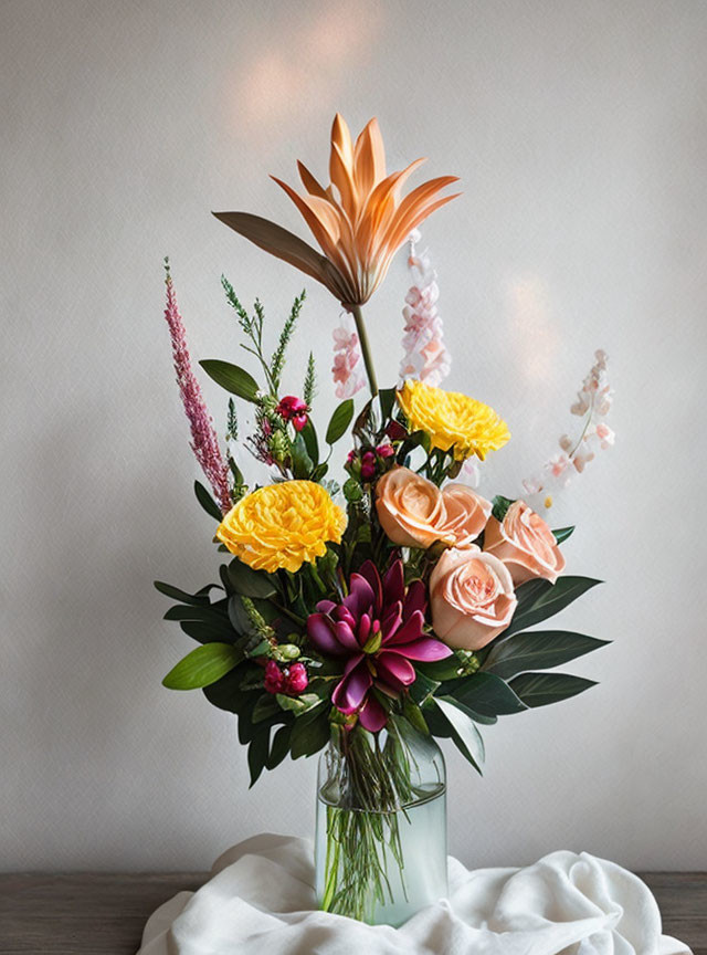 Colorful bouquet of lilies, roses, and foliage in glass vase on table