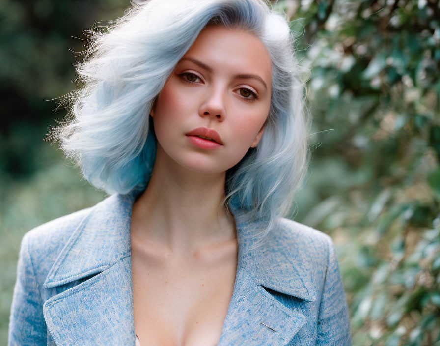 Pastel Blue-Haired Person in Blue Blazer Against Green Foliage