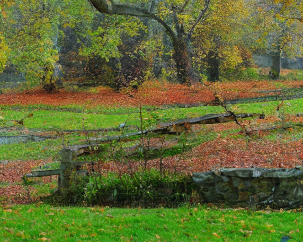 Tranquil autumn park with green grass, wooden fence, and misty trees