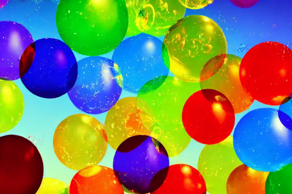 Colorful balloons in bright sky with light flares & reflections.