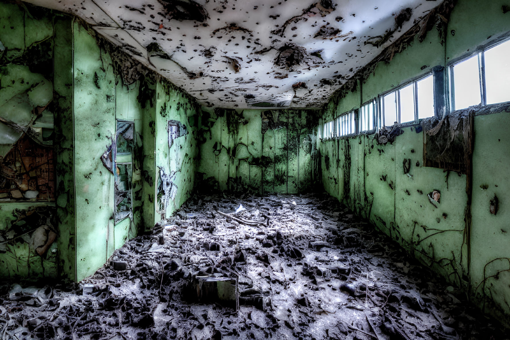 Desolate abandoned room with peeling green walls