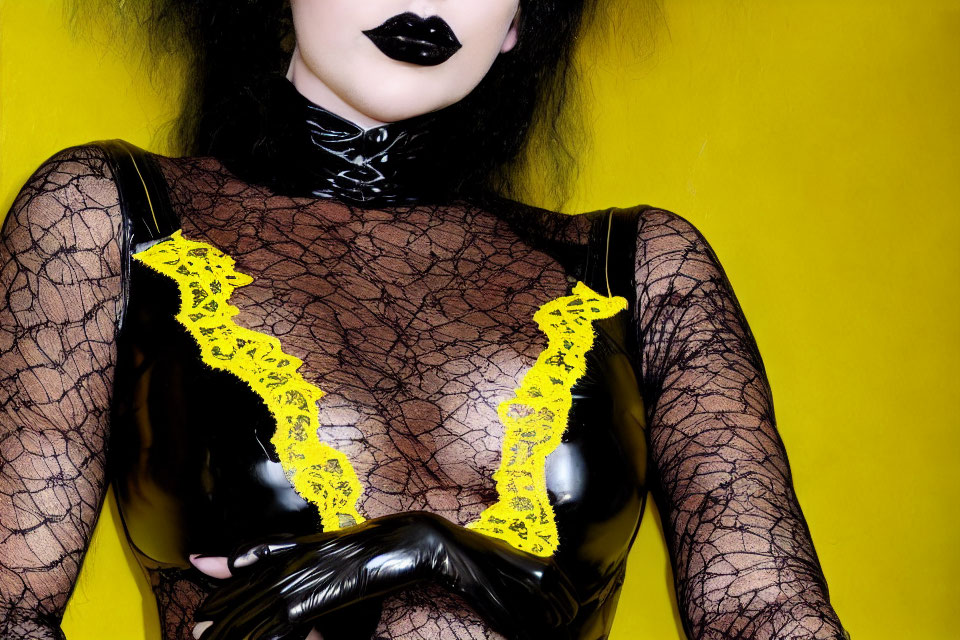 Person in black lipstick and latex attire with yellow lace on yellow background