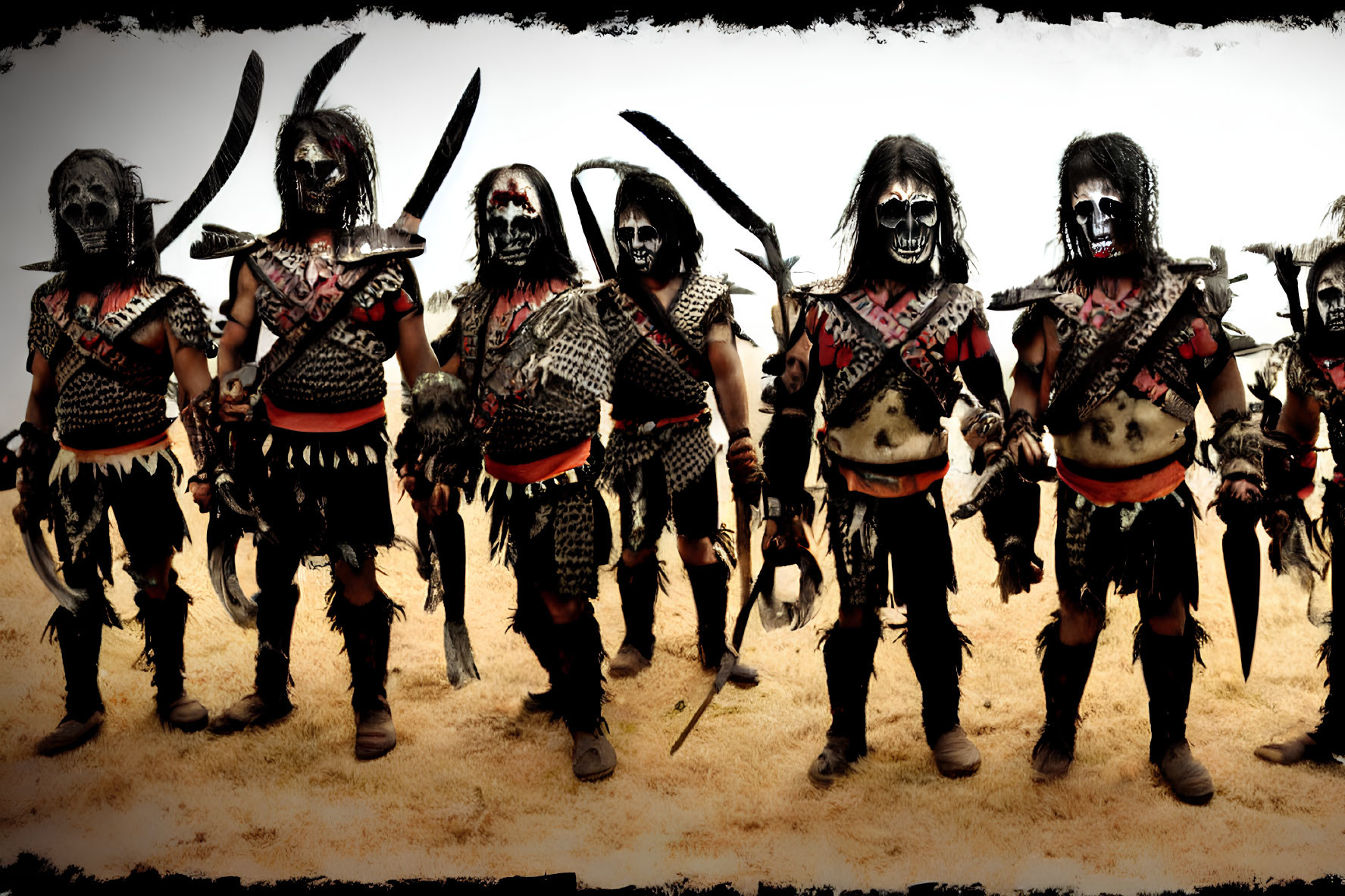 Five Tribal Warriors in Face Paint and Weapons Pose in Desert