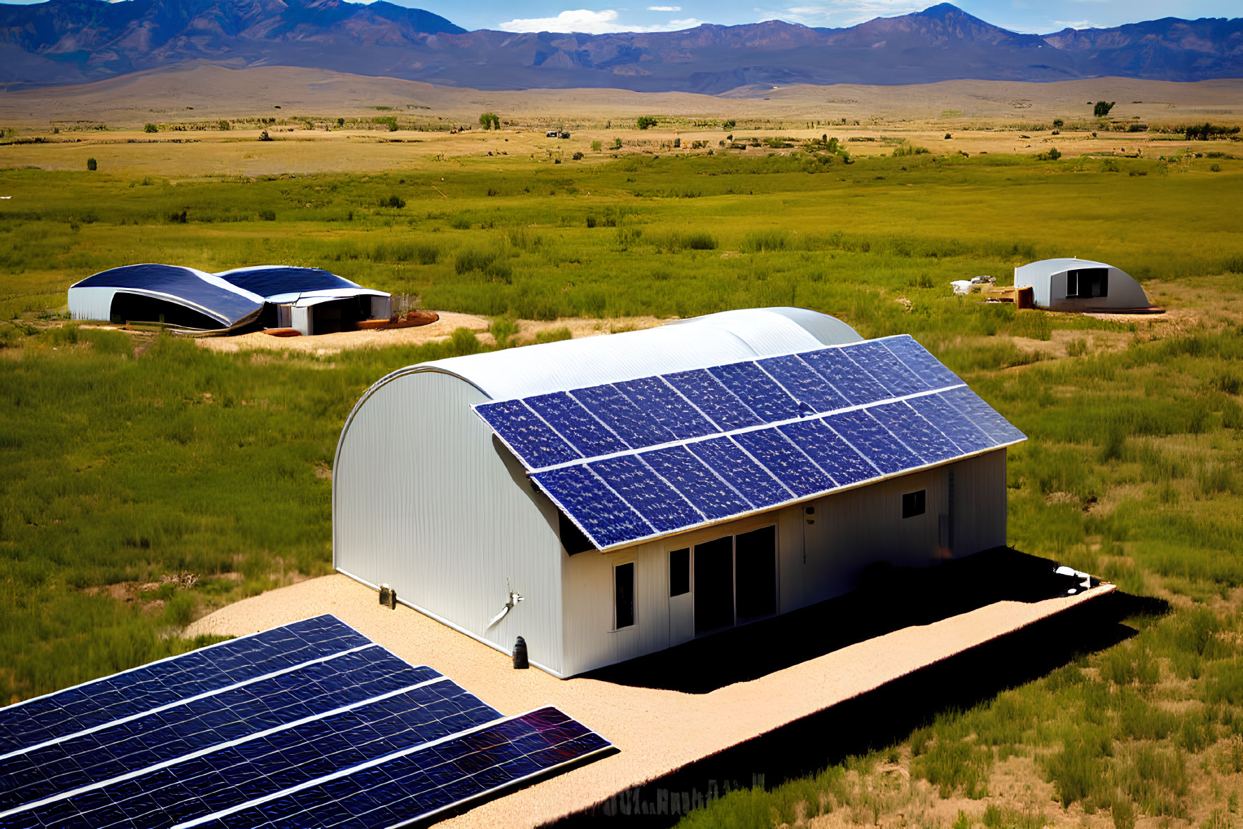 Rural landscape with buildings and solar panels under clear blue sky