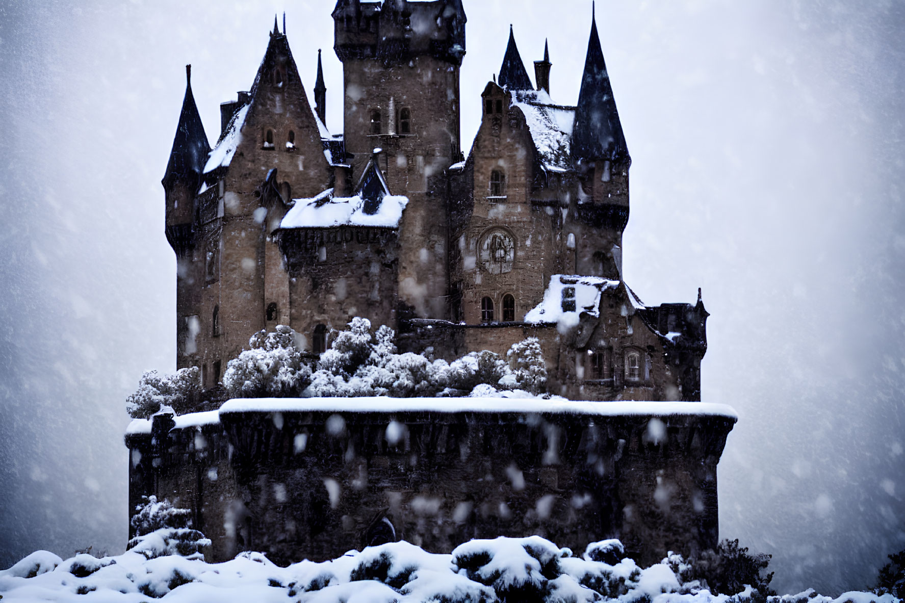 Snowy castle with spires on rocky cliff in snowfall