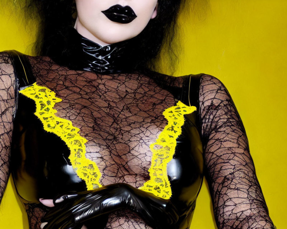 Person in black lipstick and latex attire with yellow lace on yellow background