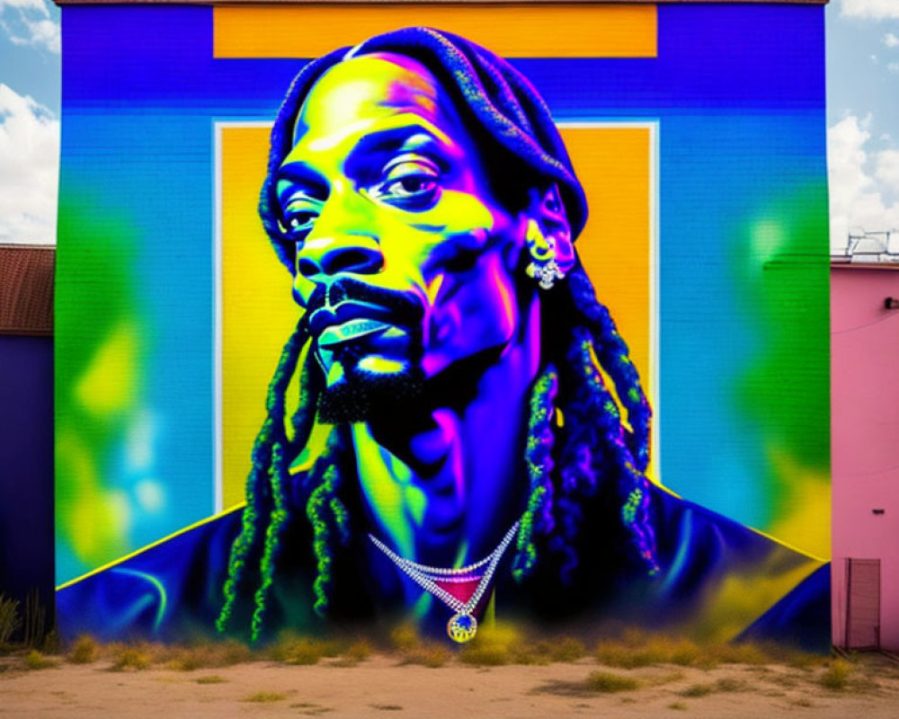 Colorful street mural featuring man with braided hair and chain necklace on geometric backdrop