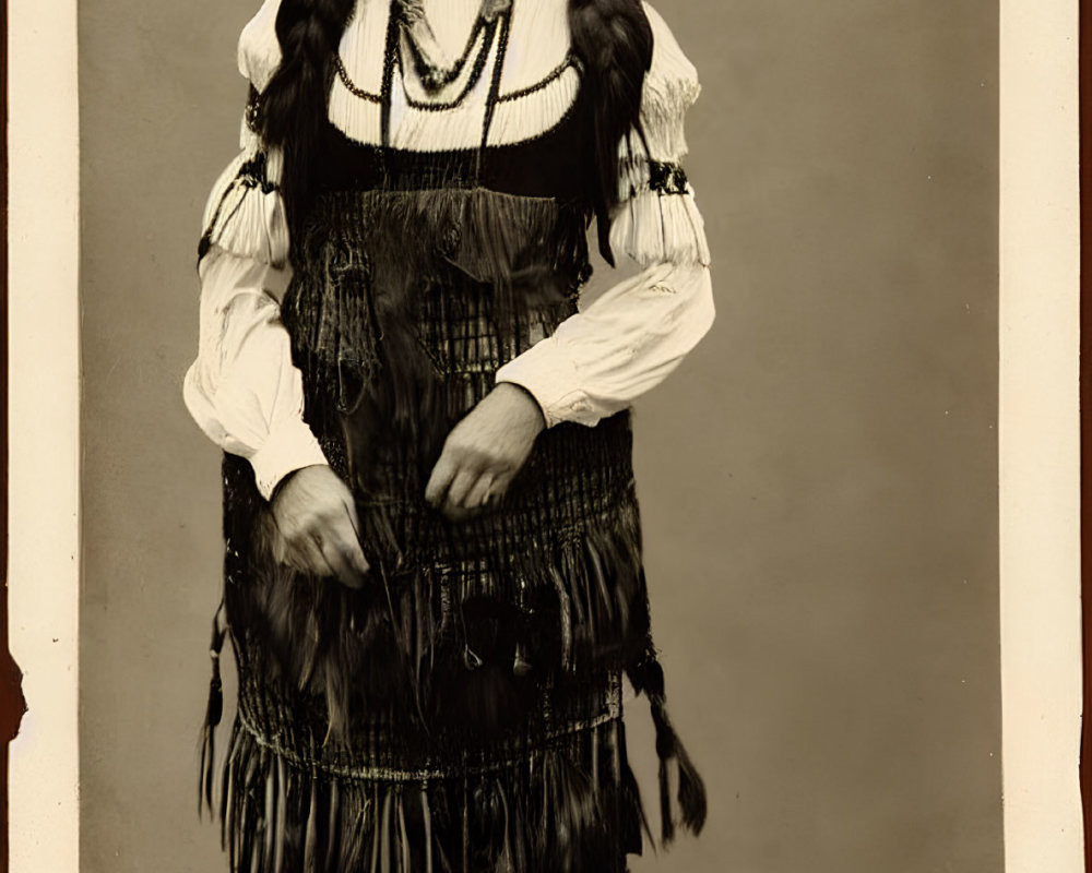 Sepia-toned photograph of person in Native American attire