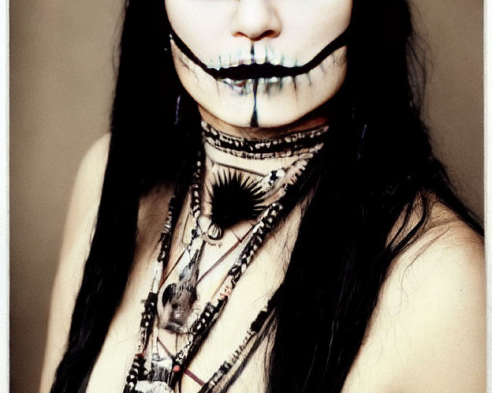 Monochrome makeup and beaded necklace portrait on blurred background