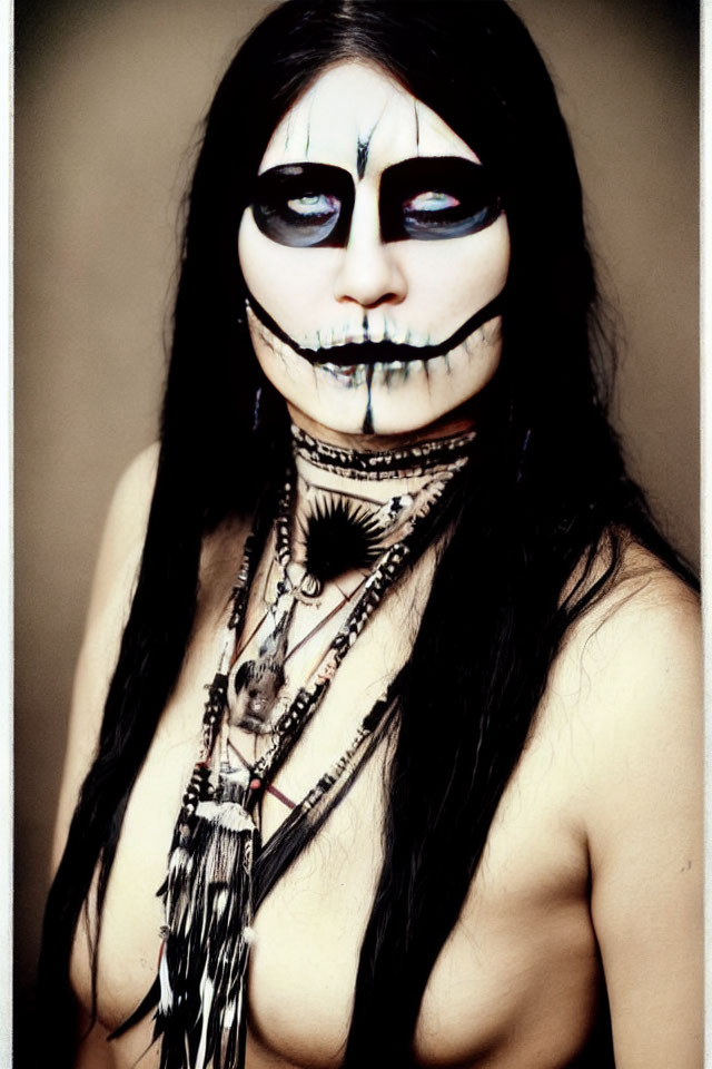 Monochrome makeup and beaded necklace portrait on blurred background