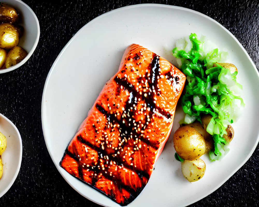 Grilled Salmon Fillet with Sesame Seeds and Roasted Potatoes on White Plate