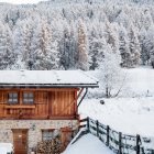 Snowy landscape with cozy wooden cabin and glowing windows