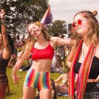 Vibrant festival attire: Three women dance in colorful scenery